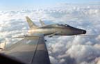 Picture of an F-100D in formation over Vietnam. 
               Click on this picture to start the video.
